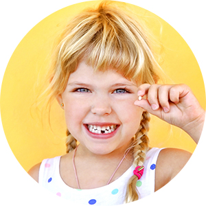 kids dentistry girl holding small tooth