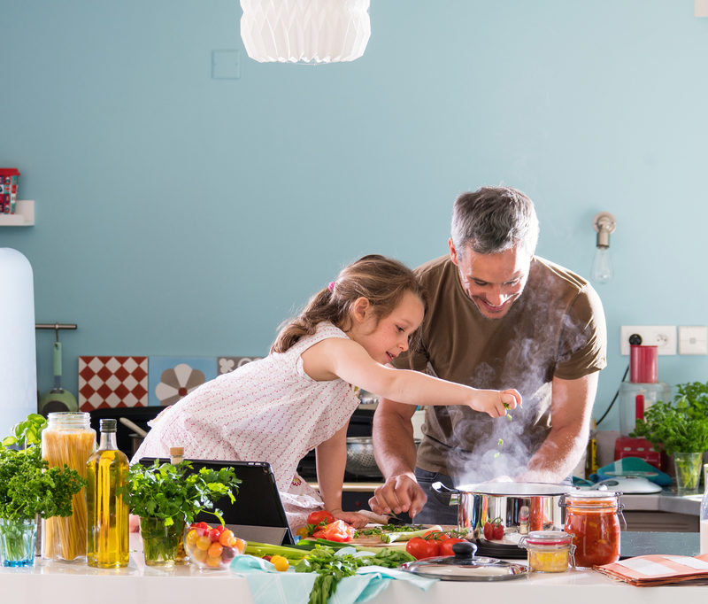 Young-girl-helping-her-dad-cook-delicious-braces-friendly-food
