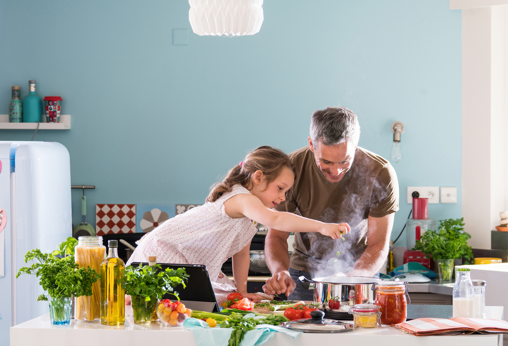 Young-girl-helping-her-dad-cook-delicious-braces-friendly-food